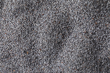 Whole black poppy seeds background