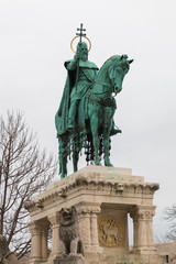 Fototapeta premium King Saint Stephen statue located near the Matthias Church and Fisherman's bastion in Buda castle on a cloudy day, Budapest, Hungary