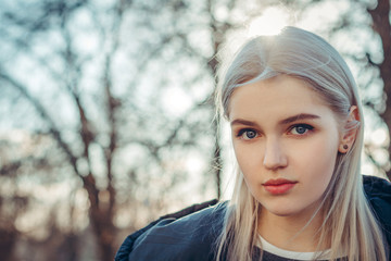 Fototapeta premium Beautiful attractive young girl in the evening in the city