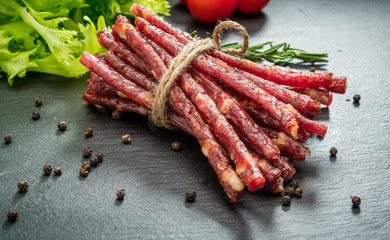 Food background. Snack stick sausages on a wooden table