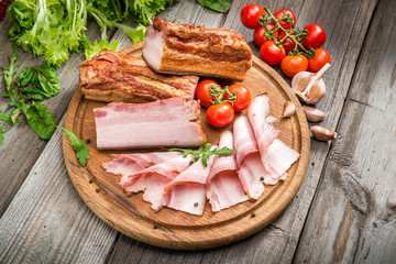 Fototapeta na wymiar Slices of bacon on the wooden background