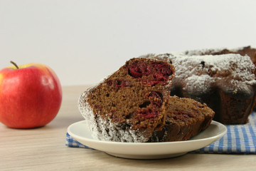Homemade cherry pie with a knitted cloth on wooden table