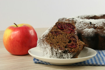 Homemade cherry pie with a knitted cloth on wooden table