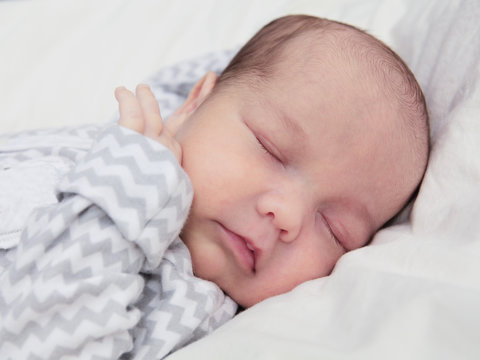 Cute newborn baby sleeping, face closeup