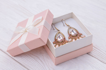Gold earrings with topaz in the gift box