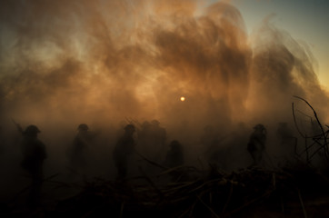 Fototapeta na wymiar War Concept. Military silhouettes and tanks fighting scene on war fog sky background, World War Soldiers Silhouettes Below Cloudy Skyline At Dusk or Dawn. Attack scene