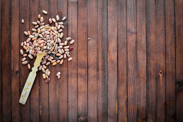 kidney beans. Wooden spoon. On Wooden background. Top view.