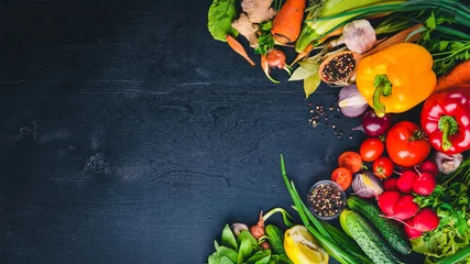 Rolgordijnen Frame of organic food. Fresh raw vegetables and spices. On a wooden chalkboard. © Yaruniv-Studio