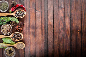 A mixture of spices. Wooden spoon. On Wooden background. Top view.