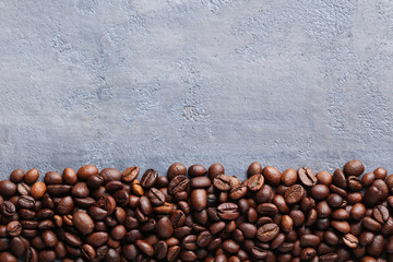 Roasted coffee beans on a grey table