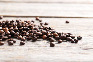 Roasted coffee beans on a grey wooden table