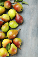 Ripe pears on grey wooden table