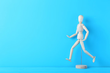 Wooden figure on the blue background