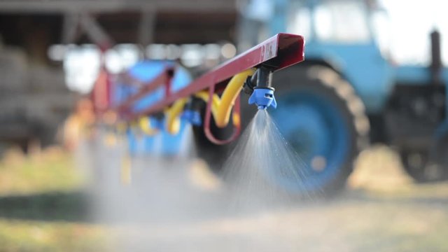 The tractor sprinkles the pesticides