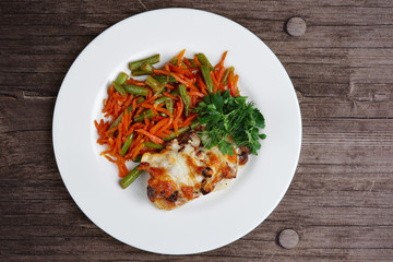 Fried chopped pork with cheese, green beans and carrot. Top view.