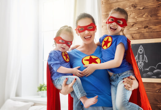 Girls and mom in Superhero costumes