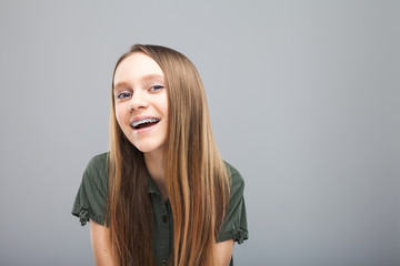 Beautiful smile girl with braces laughing