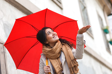 Portrait of beautiful woman with red umbrella