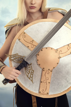 closeup woman warrior with shield and sword