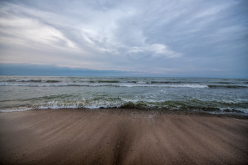 Sunset at the sea shore of a beach with rocks and stormy waves, beautiful seascape at Caspian sea Absheron, Azerbaijan Novkhani