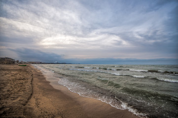 Sunset at the sea shore of a beach with rocks and stormy waves, beautiful seascape at Caspian sea Absheron, Azerbaijan Novkhani