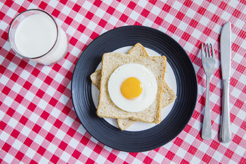 Fried egg with bread and milk