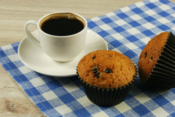 Chocolate muffins with a Cup of coffee on the table