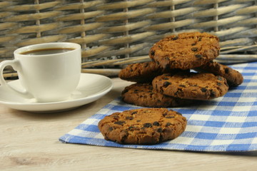 Coffee cup with oatmeal cookie chocolate on wooden background
