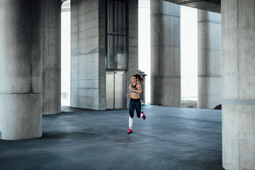 Woman running in urban environment.