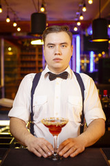 bartender presents delicious alcoholic cocktail