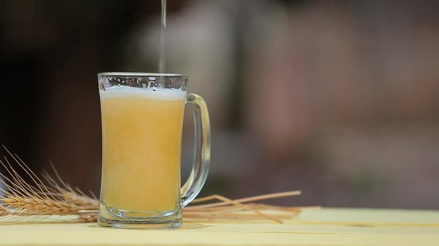 Beer pouring from bottle into glass