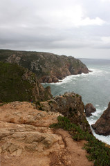 Fototapeta na wymiar Portugal. Cabo da roca. Rock and atlantic ocean on sky with clouds background, vertical view.