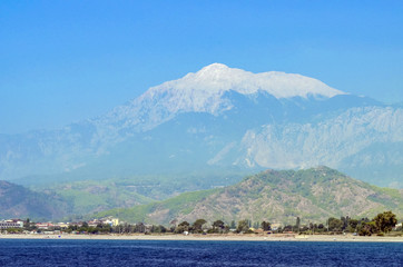 Resort Turkish. Blue water of the Mediterranean Sea. Beautiful amazing nature background. Huge rocks. Fresh freedom of the sea. Adventure day. A splendid paradise. The inspirational desert of water.