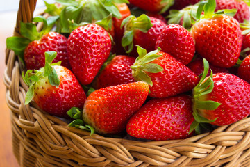 Fresh strawberries in a basket in the garden