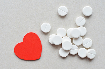 white tablets with red heart