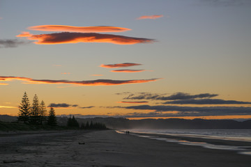 red clouds over a dark beach