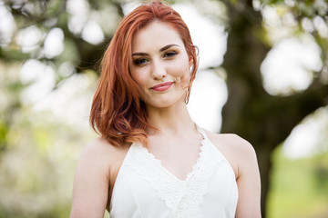 Naklejka premium Beautiful woman in white dress. Outdoor shooting. Lifestyle and relaxation