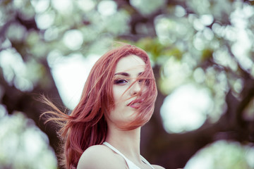 Naklejka premium Gorgeous woman with hair in wind. Outdoor shooting. Lifestyle and relaxation