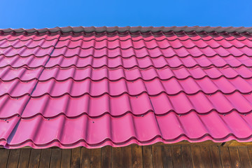 The roof of the country house is covered with metal roofing