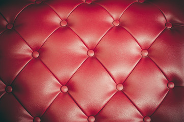 Red leather sofa backrest.
