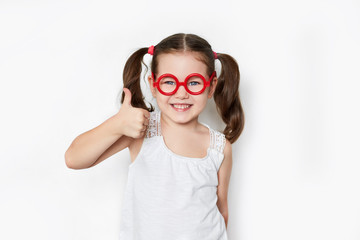 smiling little girl in red toy glasses