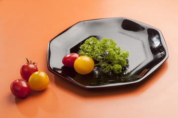 Black plate with parsley & Baby tomato with catchup  