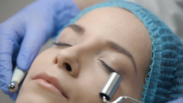Woman having a stimulating facial treatment