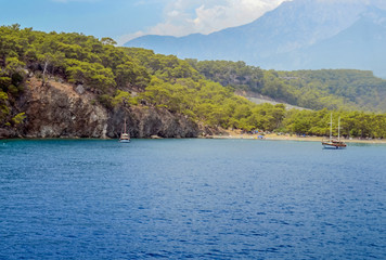 Resort Turkish. Blue water of the Mediterranean Sea. Beautiful amazing nature background. Huge rocks. Fresh freedom of the sea. Adventure day. A splendid paradise. The inspirational desert of water.