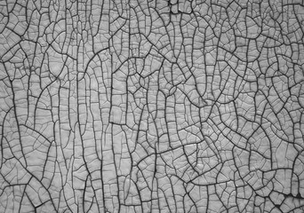Black and white texture of a wall with cracked paint
