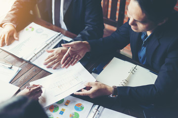 Business - meeting in an office; the businesspeople are discussing a document