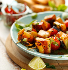 Grilled skewers of halloumi cheese and vegetables with addition aromatic herbs