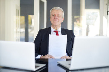 Senior manager portrait. Shot of an old overwhelmed business man working on laptop in the office.