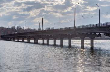 Photo of an industrial bridge through an artificial reservoir in the city.