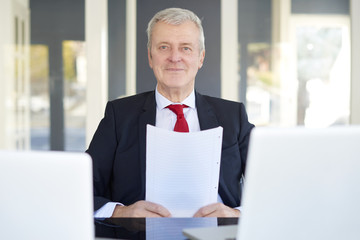 Senior manager portrait. Shot of an old overwhelmed business man working on laptop in the office.